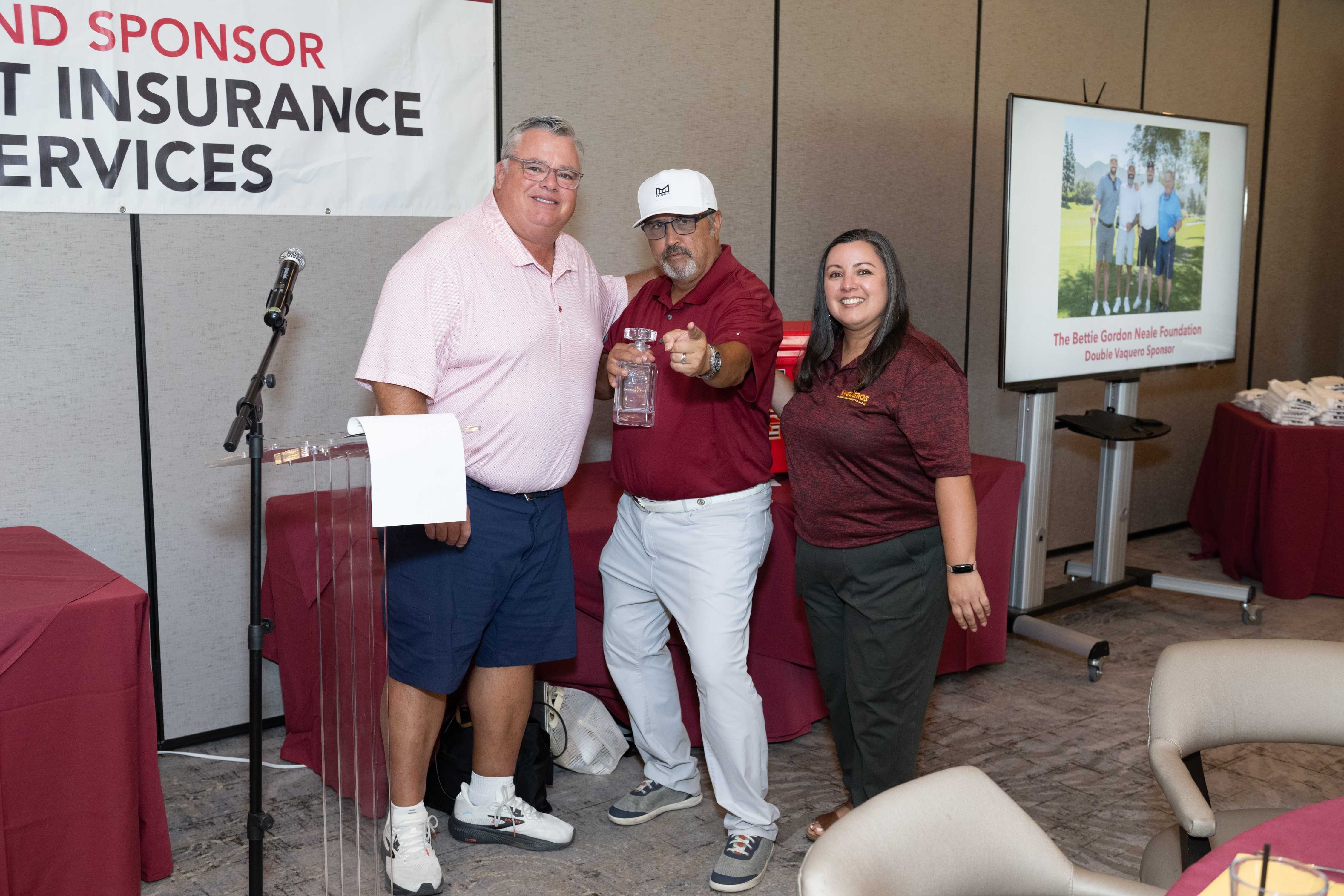 Rick Dinger and Paola Santana present the Hole 11 Closest to the Pin to Jesse Urquidi at 5 feet 6 inches.